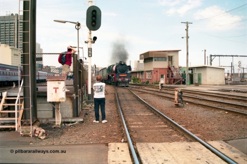 162-1-20
Spencer Street Station, broad gauge Steamrail R class R 766 North British Locomotive Company, Glasgow, Scotland model Hudson serial 27056 departs platform 4 with a down steam hauled passenger train during the PTC open Day, signal post 154 and ground dwarf 155, platform 3 visible and the Overland is visible on the far left in platform no. 2.
Keywords: R-class;R766;North-British-Locomotive-Company;Hudson;27056;