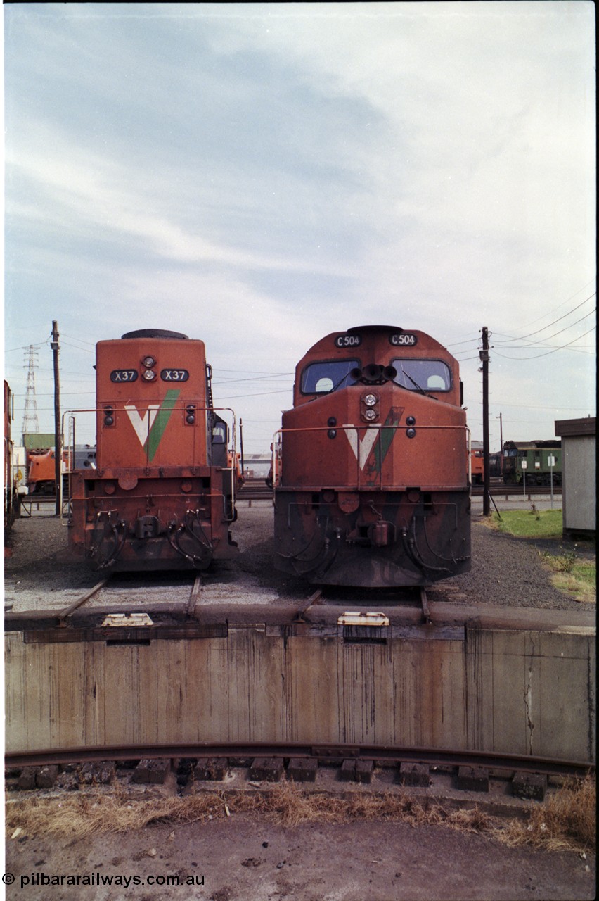 162-2-11
South Dynon Motive Power Depot, standard gauge turntable, radial roads and pit, V/Line locomotives X class X 37 Clyde Engineering EMD model G26C serial 70-700 and C class C 504 Clyde Engineering EMD model GT26C serial 76-827, cab front and long hood views, PTC Open Day.
Keywords: C-class;C504;Clyde-Engineering-Rosewater-SA;EMD;GT26C;76-827;