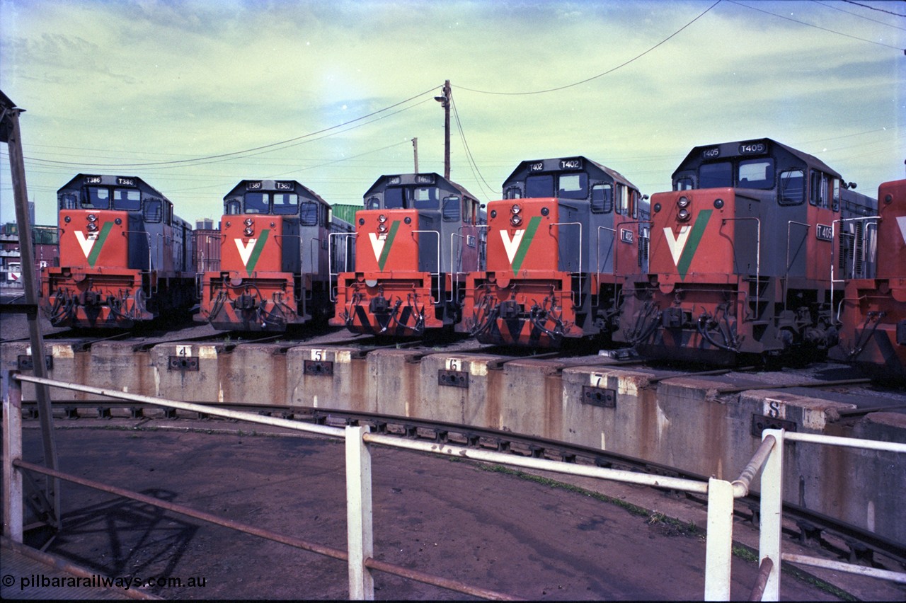 162-3-01
South Dynon Motive Power Depot, broad gauge turntable radial roads, V/Line diesel electric locomotives T class T 386 Clyde Engineering EMD model G8B serial 64-341, T 387 serial 65-417, T 401 Clyde Engineering EMD model G18B serial 67-496, T 402 serial 67-497 and T 405 serial 67-500, PTC Open Day.
Keywords: T-class;T386;Clyde-Engineering-Granville-NSW;EMD;G8B;64-341;