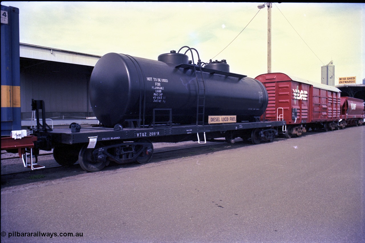 162-3-09
Melbourne Yard, V/Line broad gauge VTQZ type bogie fuel tank waggon VTQZ 209, with Diesel Loco Fuel signage, started life as a Newport Workshops built E type open waggon in 1927, converted to an OT in 1949, then an TW type bogie tank waggon TW 209 in 1961, to a VTQA in 1979. PTC Open Day.
Keywords: VTQZ-type;VTQZ209;Victorian-Railways-Newport-WS;TW-type;