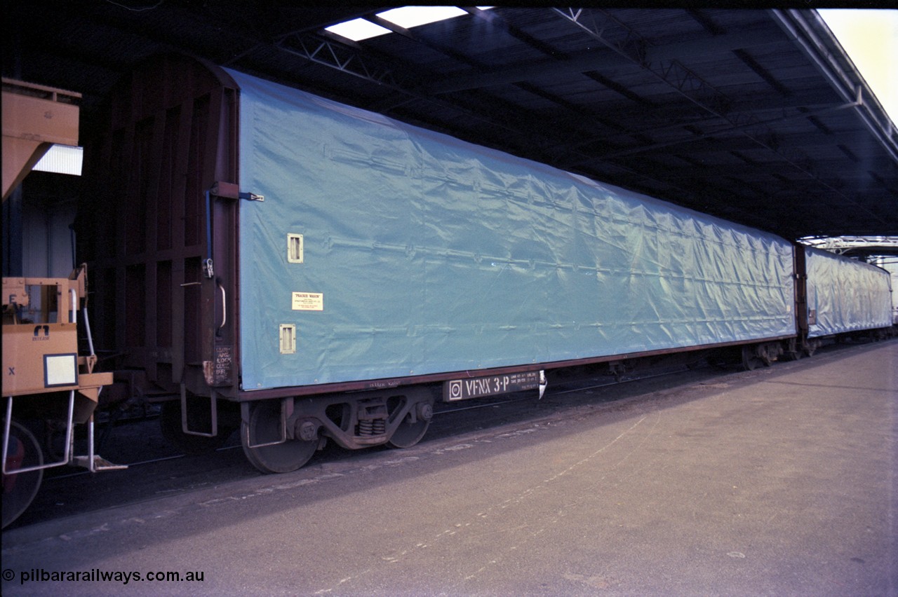162-3-13
Melbourne Yard, No.10 Goods Shed, PTC Open Day, V/Line broad gauge VFNX type bogie tarpaulin covered roll paper waggon VFNX 3 with new looking blue tarpaulin, coupled to sister waggon, built new in May 1979 at Newport Workshops.
Keywords: VFNX-type;VFNX3;Victorian-Railways-Newport-WS;