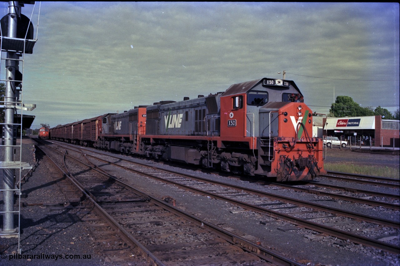 162-3-23
Seymour, rationalised yard view with stabled V/Line broad gauge down Wodonga goods train 9303 with back to back X classes X 50 Clyde Engineering EMD model G26C serial 75-797 and X 54 serial 75-801, a stabled N class N 452 is opposite the station building.
Keywords: X-class;X50;Clyde-Engineering-Rosewater-SA;EMD;G26C;75-797;