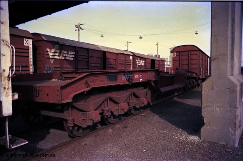 162-3-20
Melbourne Yard, broad gauge VWCF type bogie 60 ton well waggon VWCF 1, originally built at Newport Workshops 10-1925 as QB type QB 13, coded to QWF 1 in 1962, view of three axle bogie, stored.
Keywords: VWCF-type;VWCF1;Victorian-Railways-Newport-WS;QB-type;QWF-type;