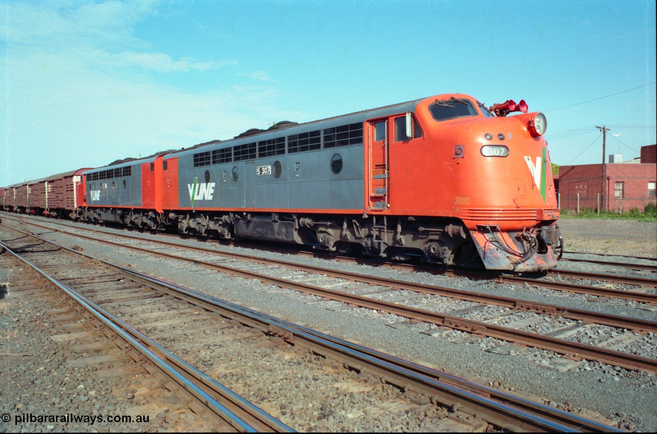 163-05
Seymour station yard, stabled V/Line down broad gauge Wodonga goods train in the rationalised yard behind the classic back to back pair of streamlined Bulldogs S classes S 307 'John Pascoe Fawkner' Clyde Engineering EMD model A7 serial 57-171' and S 311 'Sir Ferdinand von Mueller' serial 60-228 with a rake of louvre vans leading.
Keywords: S-class;S307;Clyde-Engineering-Granville-NSW;EMD;A7;57-171;bulldog;