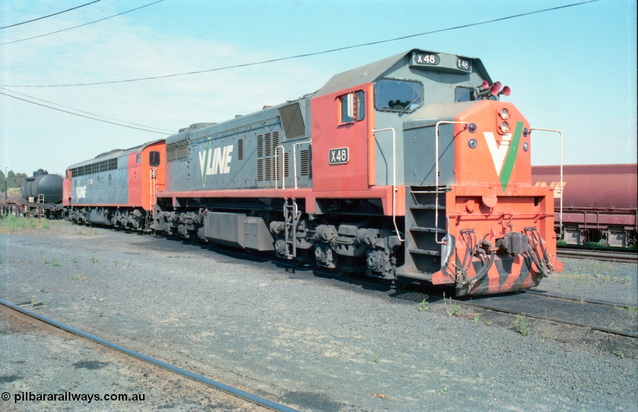 163-13
Seymour loco depot, V/Line broad gauge locomotives third series X class X 48 Clyde Engineering EMD model G26C serial 75-795 and S class S 303 'C J Latrobe' Clyde Engineering EMD model A7 serial 57-167 stabled over the weekend, bogie fuel tank and ballast waggons in the background.
Keywords: X-class;X48;Clyde-Engineering-Rosewater-SA;EMD;G26C;75-795;