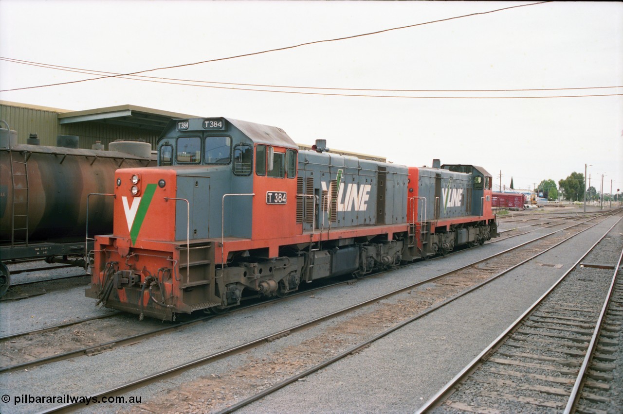 163-21
Shepparton station yard view looking north with stabled V/Line broad gauge T class locomotives T 384 Clyde Engineering EMD model G8B serial 64-339 and T 379 serial 64-334 next to the fuel train they operated the night before, goods shed is behind the consist, grounded B van in the distance.
Keywords: T-class;T384;Clyde-Engineering-Granville-NSW;EMD;G8B;64-339;