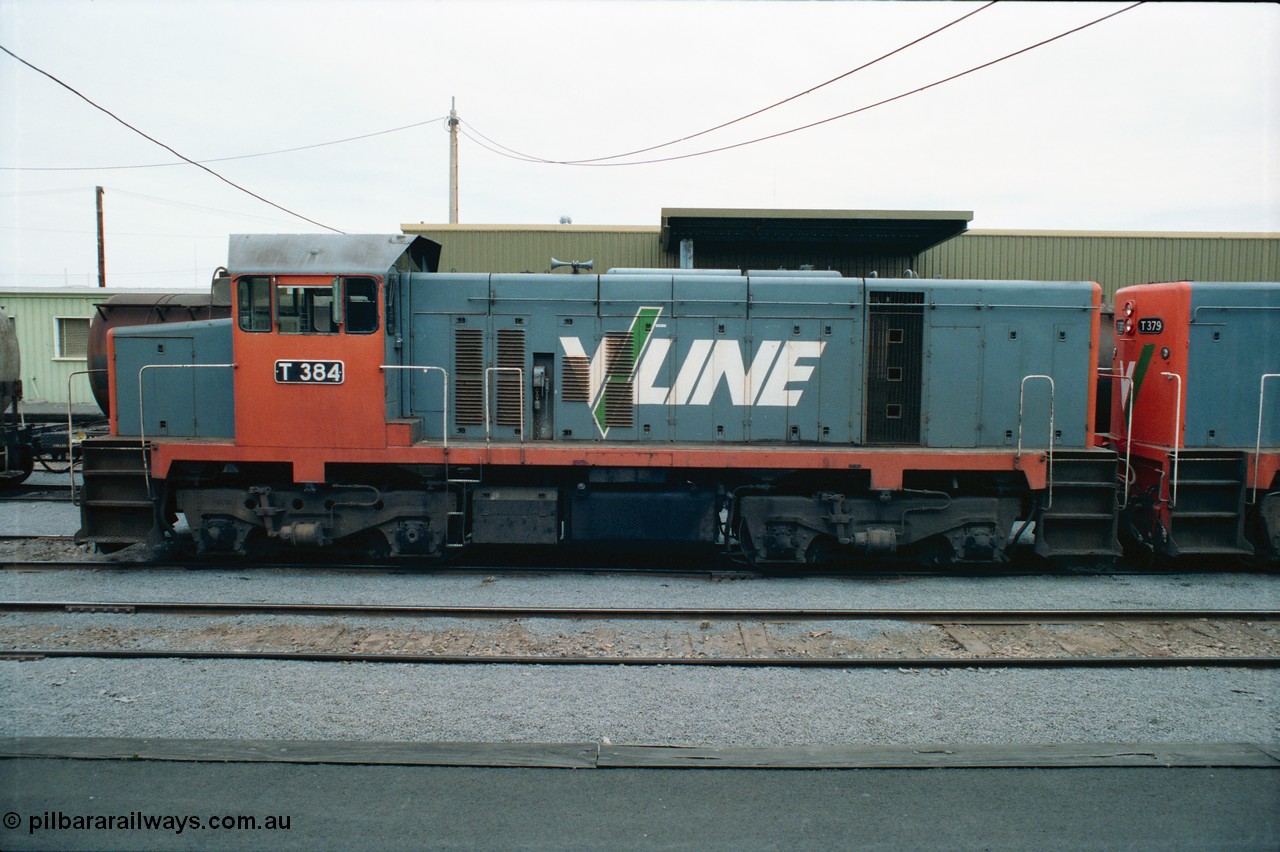 163-22
Shepparton station view from platform with stabled V/Line broad gauge T class locomotive T 384 Clyde Engineering EMD model G8B serial 64-339, goods shed behind loco, side view.
Keywords: T-class;T384;Clyde-Engineering-Granville-NSW;EMD;G8B;64-339;