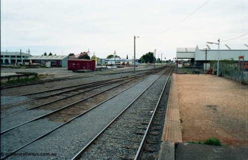 163-25
Shepparton station yard overview looking north from platform, the platform road is the line to Katamatite, with No.2 Road the line to Tocumwal, loading platform just visible and grounded B van on the left, on the right the former engine track was used by  J. Murray More Pty Ltd or Tubemakers with a 5 tonne gantry crane under the awning for unloading steel delivered by rail.
