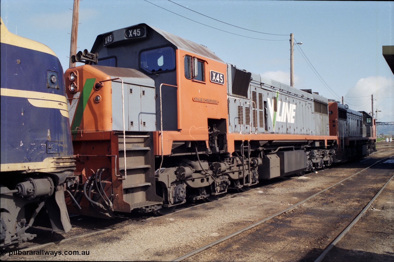 165-05
Wodonga loco depot, V/Line broad gauge X class locomotives X 45 'Edgar H Brownbill' Clyde Engineering EMD model G26C serial 75-792 and X 46 serial 75-793 stand next to the fuel point with B class B 75 waiting to run the Sunday evening Up Albury slab steel train 9334 to Long Island.
Keywords: X-class;X45;Clyde-Engineering-Rosewater-SA;EMD;G26C;75-792;