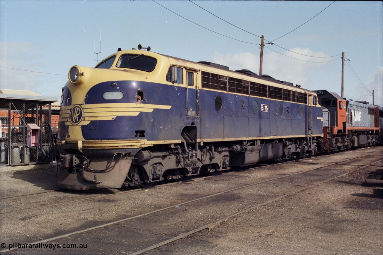 165-06
Wodonga loco depot, V/Line broad gauge Bulldog locomotive B class B 75 Clyde Engineering EMD model ML2 serial ML2-16 still in Victorian Railways livery, coupled to X class X 45 next to the fuel point.
Keywords: B-class;B75;Clyde-Engineering-Granville-NSW;EMD;ML2;ML2-16;bulldog;