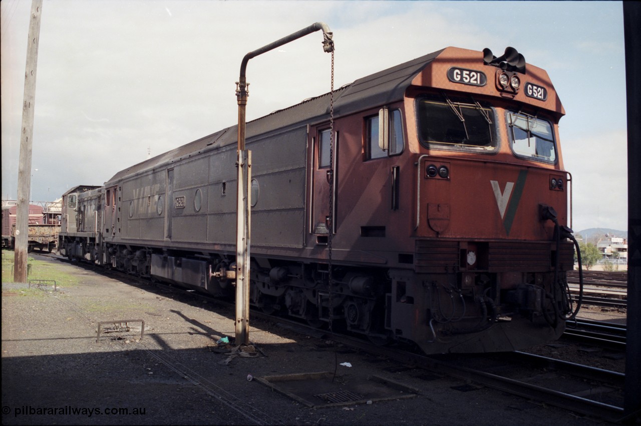 165-10
Albury loco depot, standard gauge V/Line G class G 521 Clyde Engineering EMD model JT26C-2SS serial 85-1234 with a T class, T 411?, signal box behind T class, stand pipe, turntable to left of frame.
Keywords: G-class;G521;Clyde-Engineering-Rosewater-SA;EMD;JT26C-2SS;85-1234;