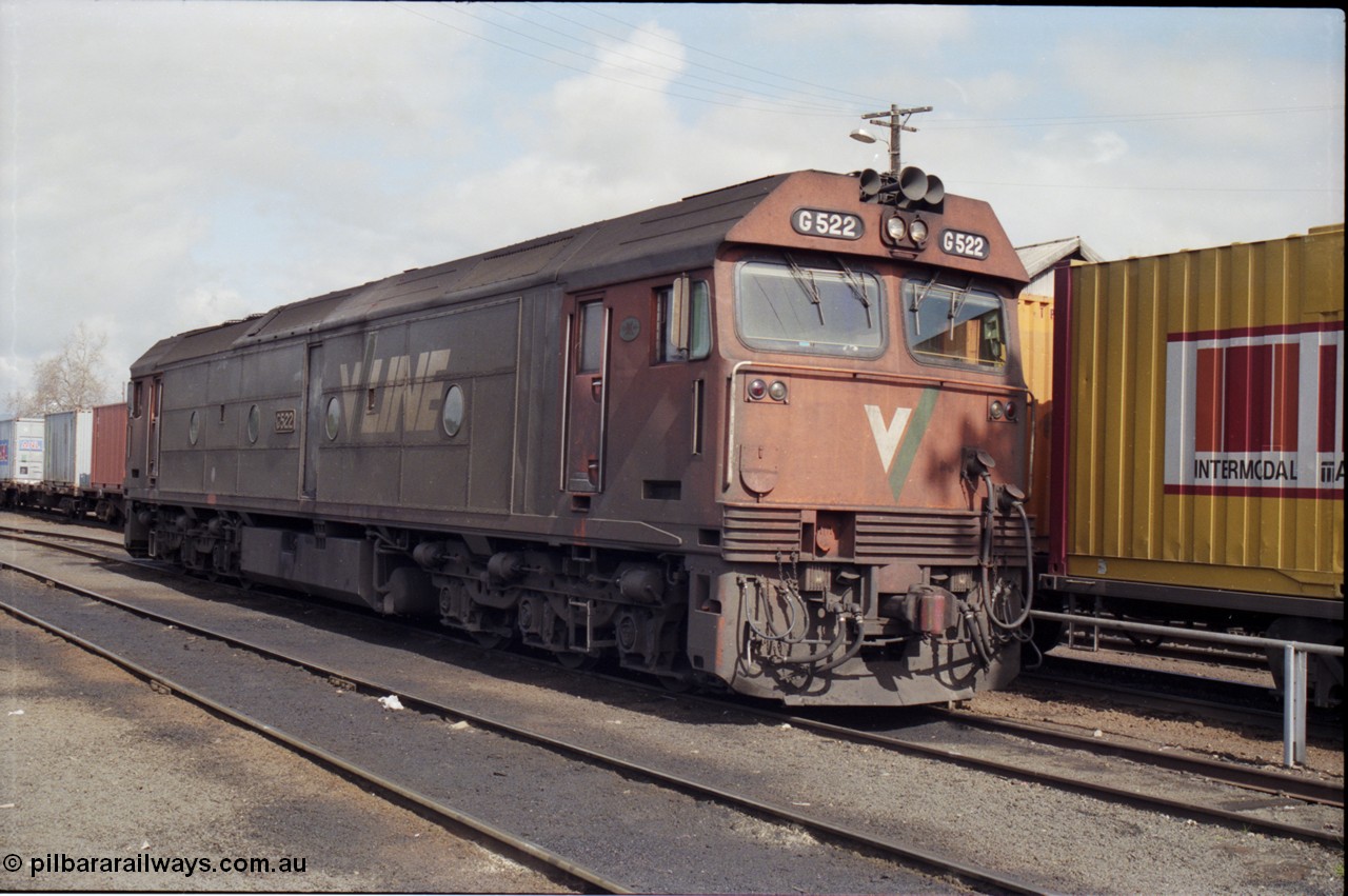 165-17
Albury loco depot, standard gauge V/Line G class unit G 522 Clyde Engineering EMD model JT26C-2SS serial 86-1235 stands next to a stabled goods train.
Keywords: G-class;G522;Clyde-Engineering-Rosewater-SA;EMD;JT26C-2SS;86-1235;