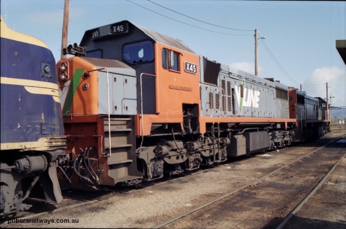 165-05
Wodonga loco depot, V/Line broad gauge X class locomotives X 45 'Edgar H Brownbill' Clyde Engineering EMD model G26C serial 75-792 and X 46 serial 75-793 stand next to the fuel point with B class B 75 waiting to run the Sunday evening Up Albury slab steel train 9334 to Long Island.
Keywords: X-class;X45;Clyde-Engineering-Rosewater-SA;EMD;G26C;75-792;