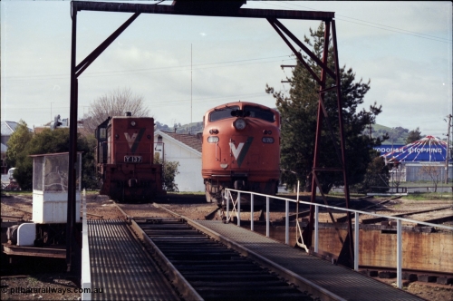165-08
Wodonga loco depot, turntable and pit, V/Line broad gauge locos framed through structure, Y class Y 137 Clyde Engineering EMD model G6B serial 65-403 and A class A 70 Clyde Engineering EMD model AAT22C-2R serial 84-1187 rebuilt from B class B 70 Clyde Engineering EMD model ML2 serial ML2-11.
Keywords: A-class;A70;Clyde-Engineering-Rosewater-SA;EMD;AAT22C-2R;84-1187;rebuild;bulldog;