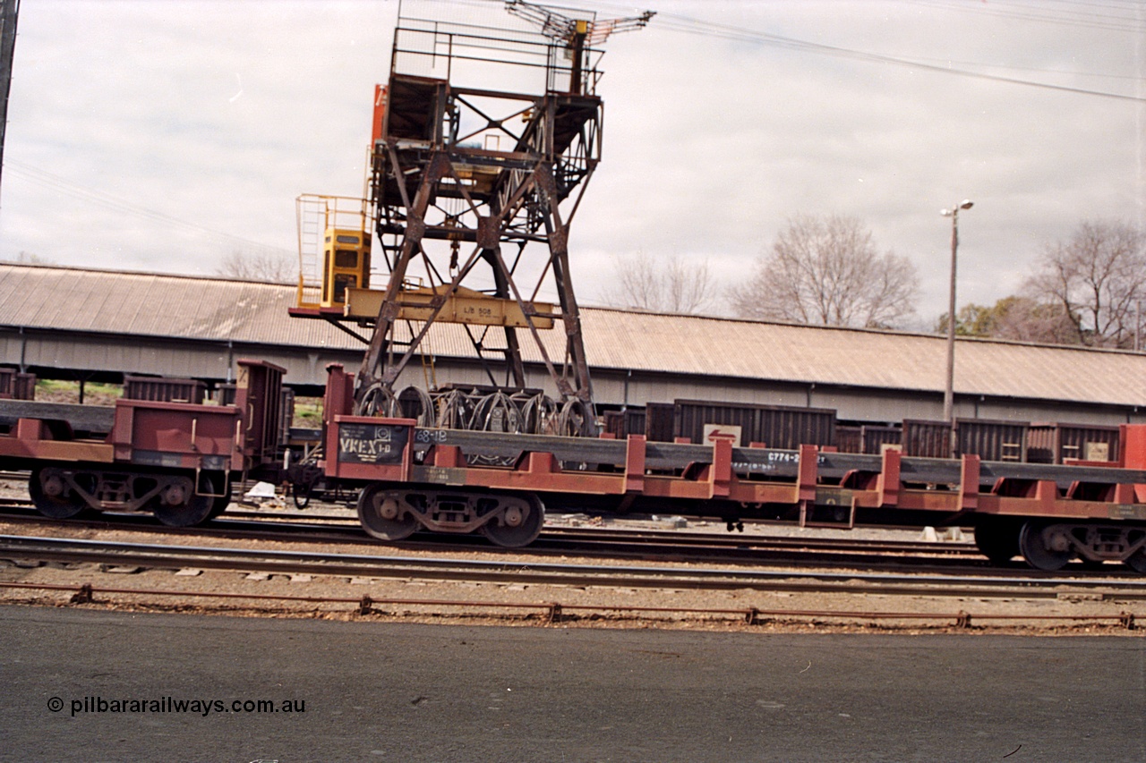 166-00
Albury yard view with trans-shipping gantry crane and shed, V/Line broad gauge bogie slab steel waggons of the VKEX type, VKEX 1 started life as an ELX built at the North Melbourne Workshops in December 1979, and NSWSRA NRJY type in the background, skewed.
Keywords: VKEX-type;VKEX1;ELX-type;