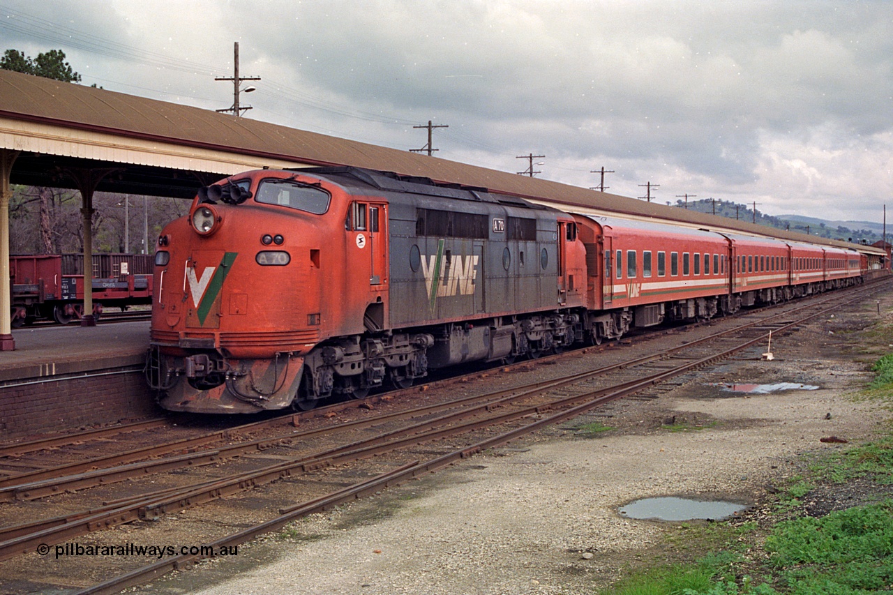 166-03
Albury, V/Line broad gauge A class A 70 Clyde Engineering EMD model AAT22C-2R serial 84-1187 rebuilt from B class B 70 Clyde Engineering EMD model ML2 serial ML2-11 arrives at the Victorian platform with an empty carriage set to work an up passenger train to Melbourne.
Keywords: A-class;A70;Clyde-Engineering-Rosewater-SA;EMD;AAT22C-2R;84-1187;rebuild;bulldog;