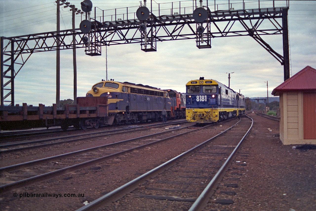 166-10
Albury, South Yard area, brand new NSWSRA 81 class locomotive 8181 Clyde Engineering EMD model JT26C-2SS serial 91-1278 in Freight Rail Stealth livery shunts back to loco with a sister unit passing aging V/Line broad gauge B class loco B 75 Clyde Engineering EMD model ML2 serial ML2-16 still in original Victorian Railways blue and yellow livery as third unit on the up Long Island slab steel train 9334 as it awaits departure time
Keywords: 81-class;8181;Clyde-Engineering-Kelso-NSW;EMD;JT26C-2SS;91-1278;