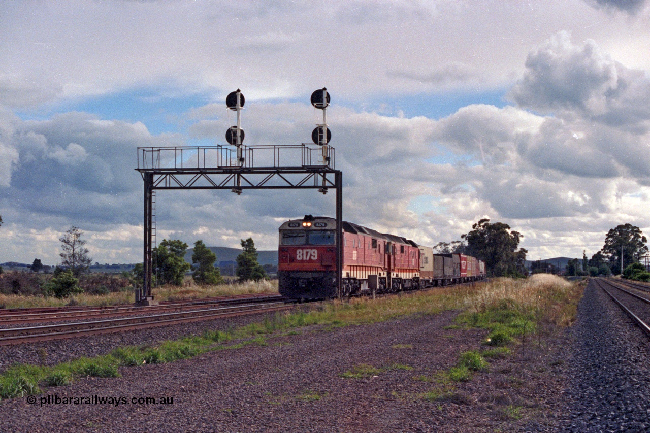 167-00
Wallan Loop north end NSWSRA standard gauge candy liveried 81 class locos 8179 Clyde Engineering EMD model JT26C-2SS serial 85-1098 and sister power an Albury bound goods service, broad gauge lines on the right.
Keywords: 81-class;8179;Clyde-Engineering-Kelso-NSW;EMD;JT26C-2SS;85-1098;