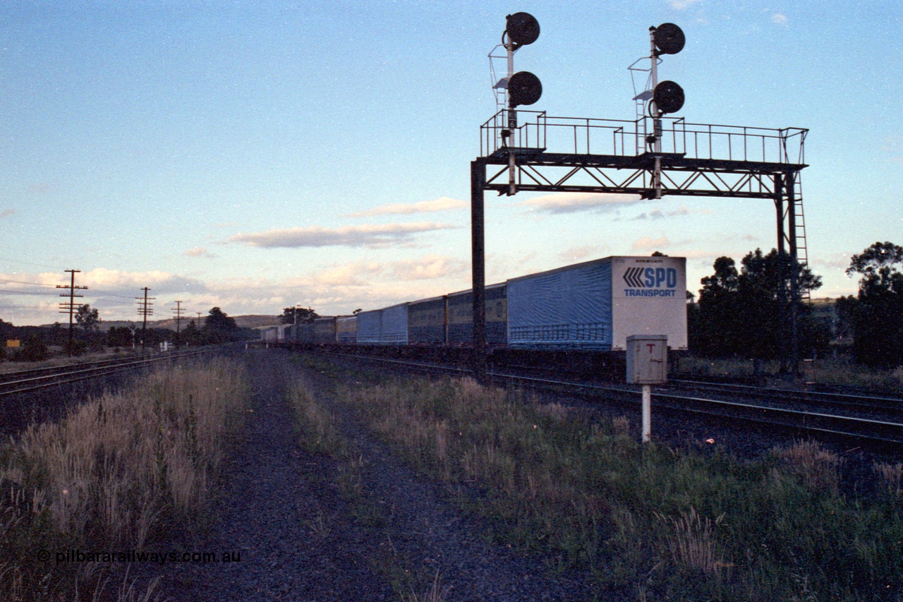 167-11
Wallan Loop, north end of standard gauge crossing loop, north bound goods end of train under signal gantry looking north, trailing view.
