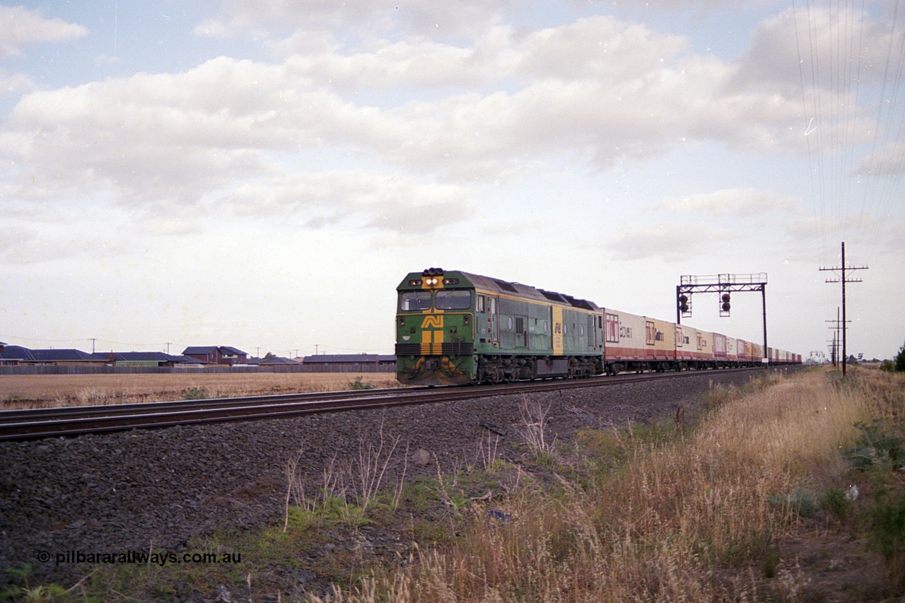 168-01
Deer Park West, broad gauge Australian National BL class BL 31 Clyde Engineering EMD model JT26C-2SS serial 83-1015 leads an Adelaide bound down goods train near Robinson Road, signal gantry for up movements with searchlight signals 1/22 and 1/10.
Keywords: BL-class;BL31;Clyde-Engineering-Rosewater-SA;EMD;JT26C-2SS;83-1015;