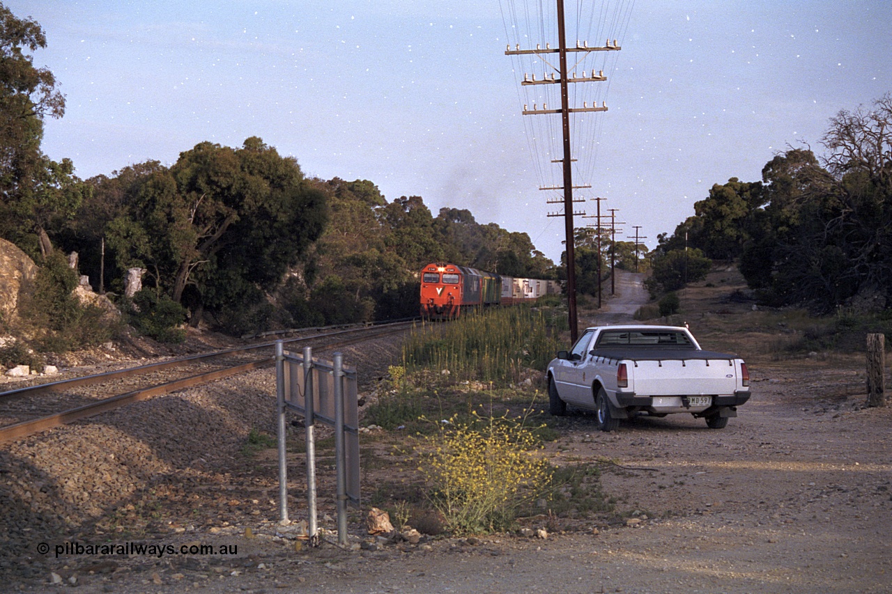 168-07
Bank Box Loop, down V/Line broad gauge goods train to Adelaide with G class G 540 Clyde Engineering EMD model JT26C-2SS serial 89-1273 and Australian National 700 class 704 AE Goodwin ALCo model DL500G serial G6059-2 power away from the crossing loop at the Ironbark Road grade crossing.
