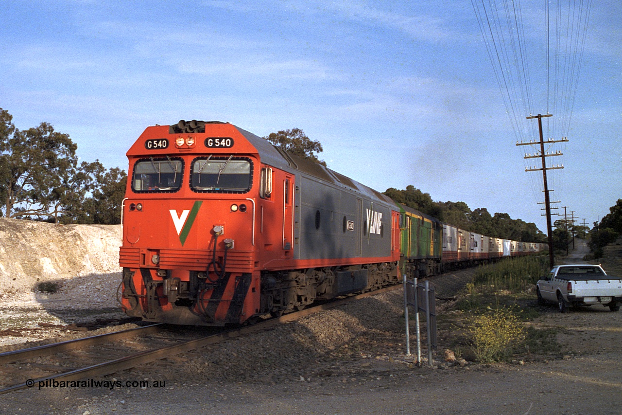 168-09
Bank Box Loop, down V/Line broad gauge goods train to Adelaide with G class G 540 Clyde Engineering EMD model JT26C-2SS serial 89-1273 and Australian National 700 class 704 AE Goodwin ALCo model DL500G serial G6059-2 power away from the crossing loop at the Ironbark Road grade crossing.
Keywords: G-class;G540;Clyde-Engineering-Somerton-Victoria;EMD;JT26C-2SS;89-1273;