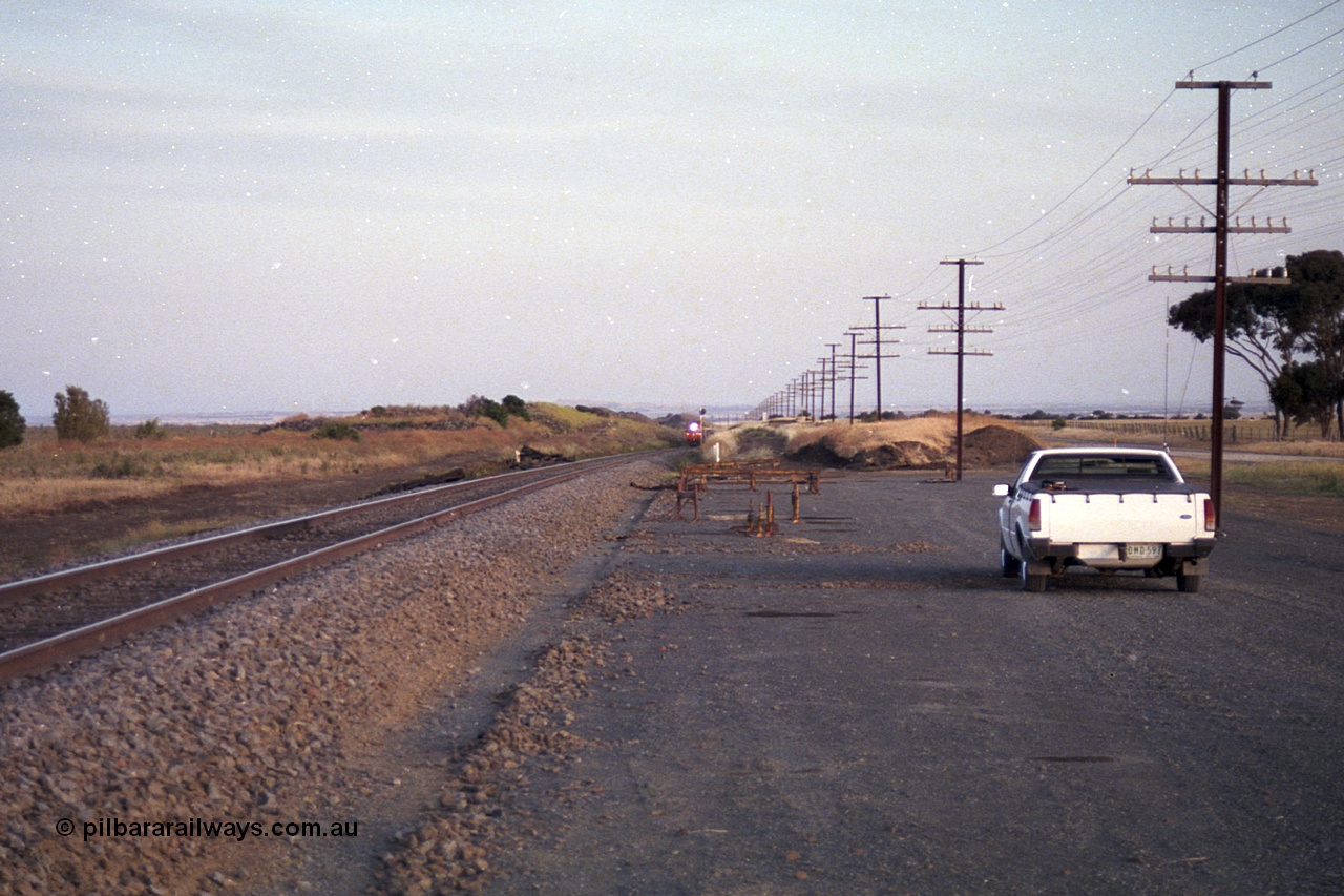 168-11
Bank Box Loop, climbing the grade in the distance looking towards Bacchus Marsh are a pair of V/Line G class units with an Adelaide bound freighter.
