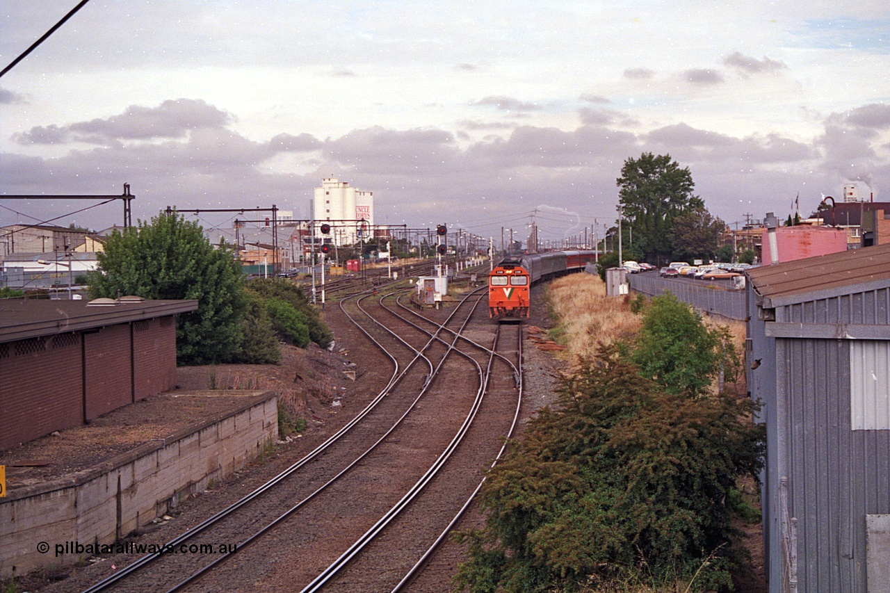 168-20
West Footscray, track view looking west toward Tottenham at broad gauge separation junction, V/Line standard gauge G class locomotive G 518 Clyde Engineering EMD model JT26C-2SS serial 85-1231 leads the up Melbourne Express passenger service from Sydney.
Keywords: G-class;G518;Clyde-Engineering-Rosewater-SA;EMD;JT26C-2SS;85-1231;