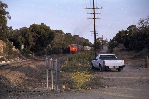 168-07
Bank Box Loop, down V/Line broad gauge goods train to Adelaide with G class G 540 Clyde Engineering EMD model JT26C-2SS serial 89-1273 and Australian National 700 class 704 AE Goodwin ALCo model DL500G serial G6059-2 power away from the crossing loop at the Ironbark Road grade crossing.
