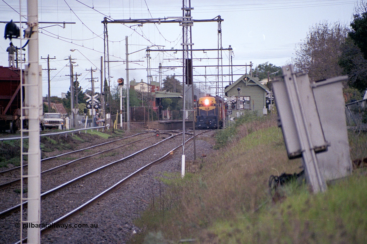 169-01
Spotswood, distant view looking towards Newport, former Victorian Railways and ex. Australian - Portland Cement broad gauge T class locomotive T 413 Clyde Engineering EMD model G8B serial 56-107 leads an up special at the platform, signal box on the right and banner signal U6 on the left with dwarf signal 8 in-between running lines.
Keywords: T-class;T413;56-107;Clyde-Engineering-Granville-NSW;EMD;G8B;