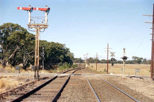 171-17
Buangor station yard overview, looking towards Melbourne, east end of loop, up home semaphore signal Post 3, point rodding and signal wires, High Street grade crossing and semaphore signal Post 2 facing down trains in the distance.
