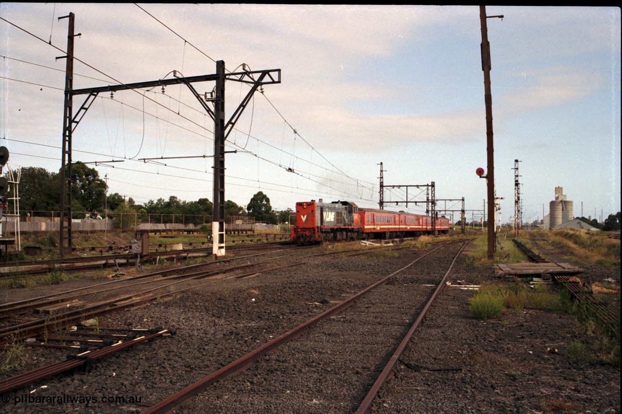 172-06
Sunshine, broad gauge down passenger service lead by a V/Line P class P 17 Clyde Engineering EMD model G18HBR serial 84-1216 rebuilt from T 327 Clyde Engineering EMD model G8B serial 56-78 hauling a 4 car H set, another point of this image is the amount of point rodding running around the place and the standard gauge platform in the background.
Keywords: P-class;P17;Clyde-Engineering-Somerton-Victoria;EMD;G18HBR;84-1216;rebuild;