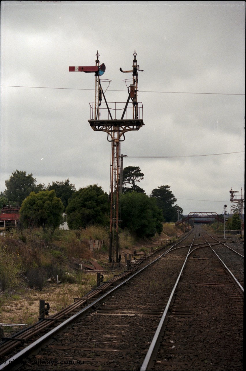 172-21
Ballarat East, semaphore signal post 4, looking east towards Warrenheip, point rodding and points, Queen Street bridge in the background, new electric colour light signal post also visible.
