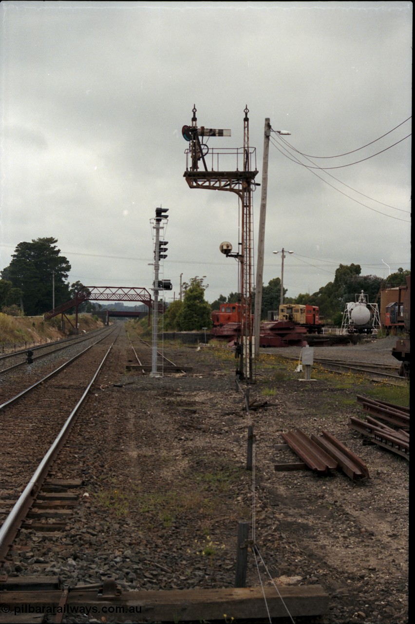 172-22
Ballarat East, semaphore signal post 3, looking east towards Warrenheip, new electric colour light signal post stands at the end of the former Eureka line, Queen Street bridge visible in the background, Ballarat East loco depot on the right.
