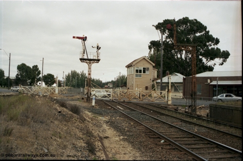 172-20
Ballarat East signal box, track view looking west across Humffray Street interlocked gates, semaphore signal post 5 and disc signal post 5A frame the gates, the former passenger platform is visible on the right.

