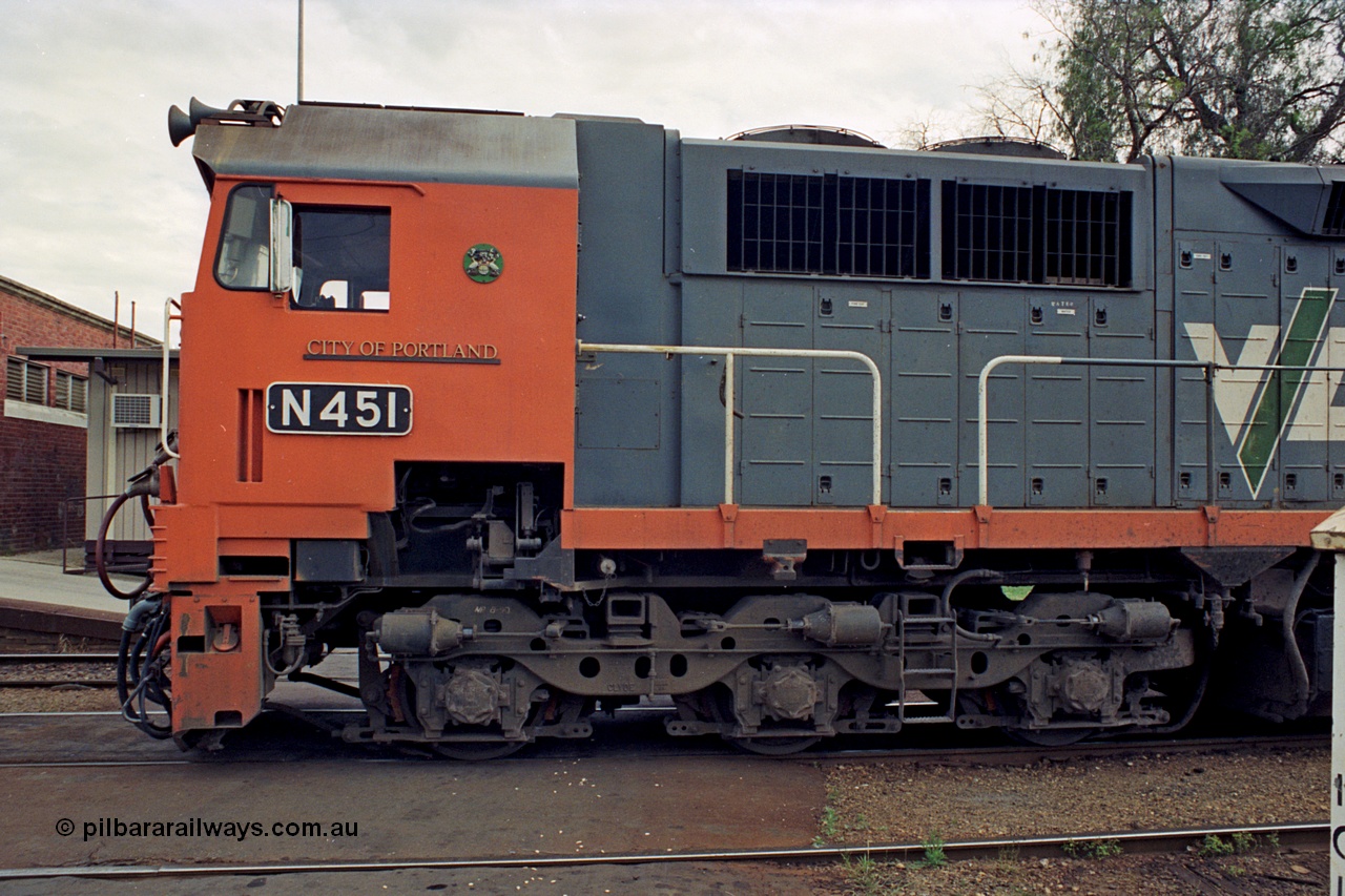 174-04
Wodonga, V/Line broad gauge locomotive N class leader N 451 'City of Portland' Clyde Engineering EMD model JT22HC-2 serial 85-1219, cab side view of nameplate, crest and number plate, bogie and staff exchanger detail.
Keywords: N-class;N451;Clyde-Engineering-Somerton-Victoria;EMD;JT22HC-2;85-1219;