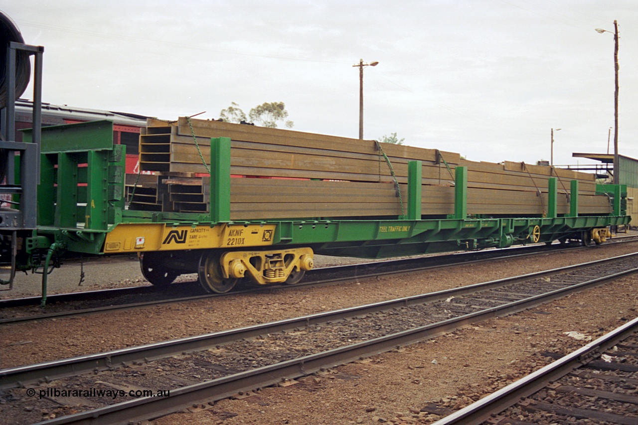 174-11
Albury, yard view, Australian National standard gauge AKNF type bogie steel transport waggon AKNF 2210 built by Mechanical Handling Ltd SA in 1970 as RN type, recoded to AFNY, converted to bulk steel in 1987, with a load of I beams on a south bound Melbourne goods train, fuel point is visible behind waggon.
Keywords: AKNF-type;AKNF2210;Mechanical-Handling-Ltd-SA;RN-type;AFNY-type;