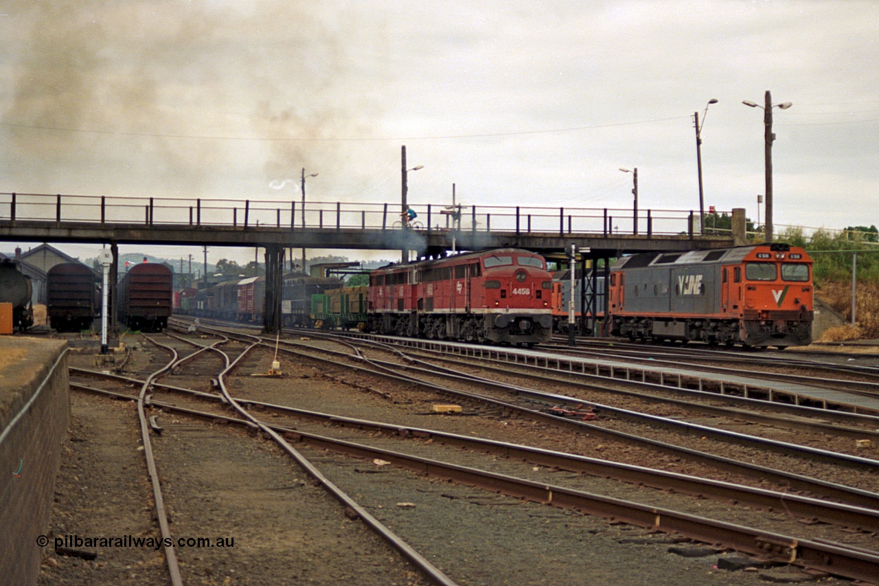 174-22
Albury, yard view from station dock area, NSWSRA standard gauge Red Terror liveried pair of 44 class 4456 AE Goodwin ALCo model DL500B serial 83746 and 4458 AE Goodwin ALCo model DL500B serial 83748 shunt the north with a Melbourne bound goods train, the broad gauge diamond is visible cutting across to the left.
Keywords: 44-class;4456;AE-Goodwin;ALCo;DL500B;83746;