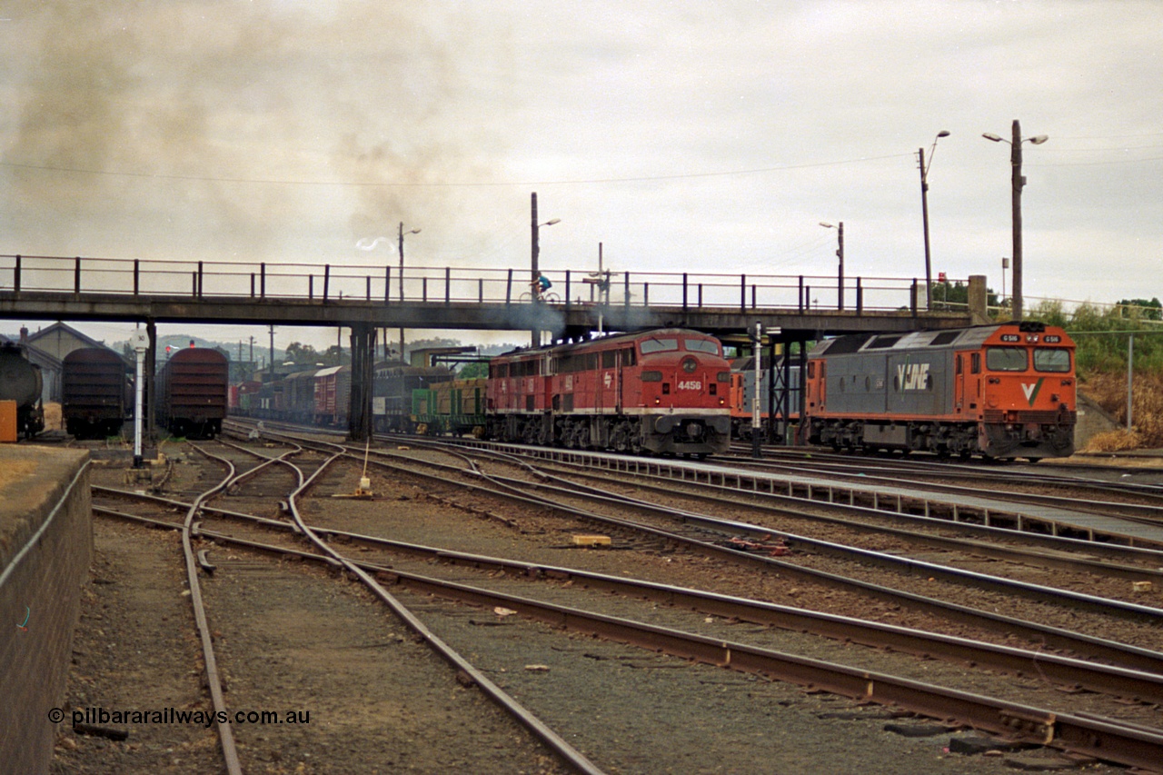 174-22
Albury, yard view from station dock area, NSWSRA standard gauge Red Terror liveried pair of 44 class 4456 AE Goodwin ALCo model DL500B serial 83746 and 4458 AE Goodwin ALCo model DL500B serial 83748 shunt the north with a Melbourne bound goods train, the broad gauge diamond is visible cutting across to the left.
Keywords: 44-class;4456;AE-Goodwin;ALCo;DL500B;83746;