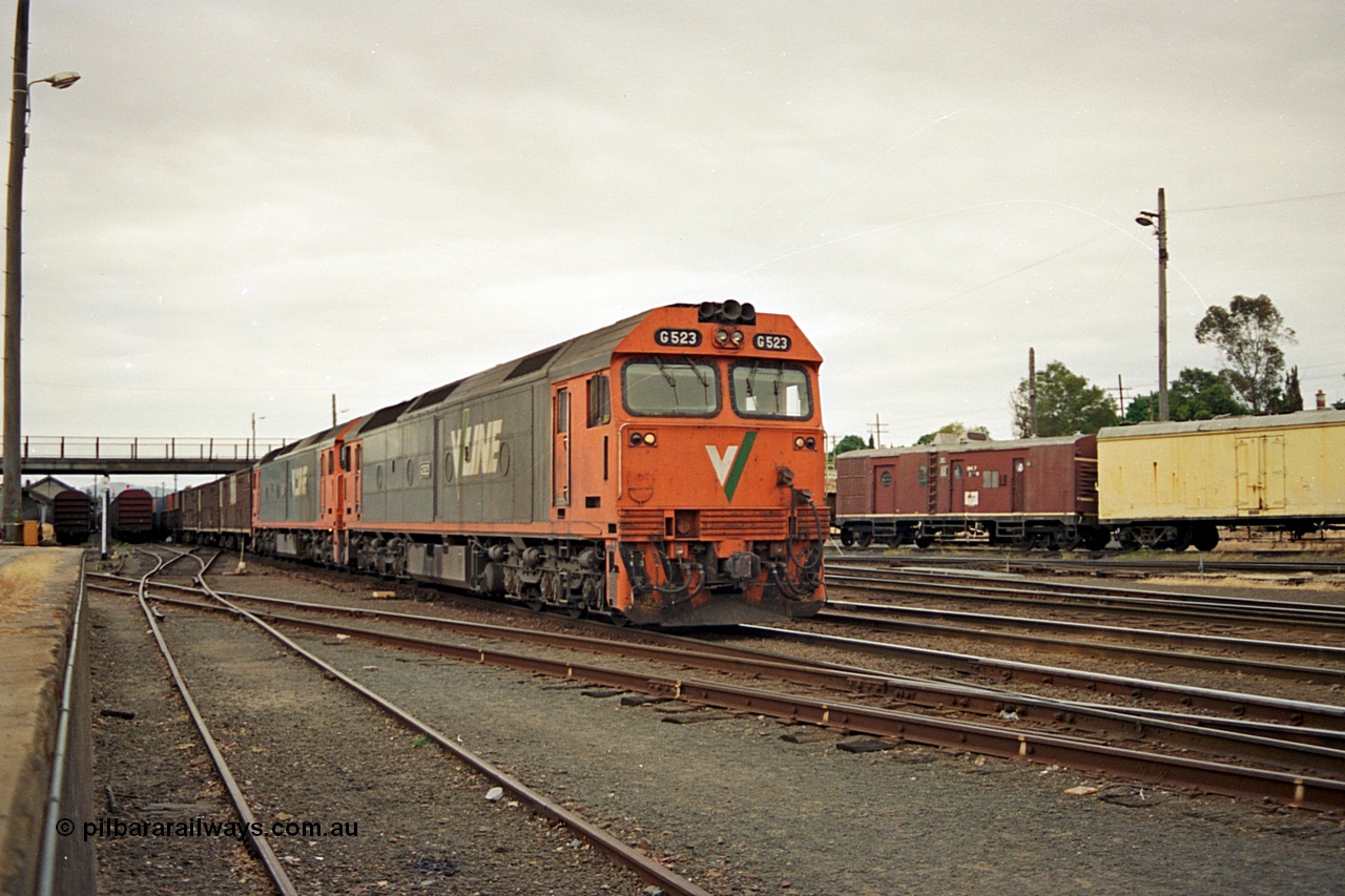 174-24
Albury, yard view from station dock area, V/Line standard gauge G class locomotives G 523 Clyde Engineering EMD model JT26C-2SS serial 86-1236 and a sister lead an up Melbourne bound goods train away from the north yard, the broad gauge track and diamond can be seen running across the dock road.
Keywords: G-class;G523;Clyde-Engineering-Rosewater-SA;EMD;JT26C-2SS;86-1236;