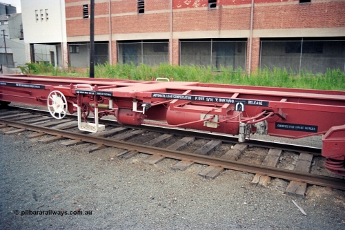174-21
Albury, V/Line standard gauge VQAW type leader VQAW 1, three pack articulated container waggon built new at Ballarat North Workshops and issued to traffic 22-11-1990, detail of brake arrangement and hand brake, empty on a south bound goods train.
Keywords: VQAW-type;VQAW1;V/Line-Ballarat-Nth-WS;