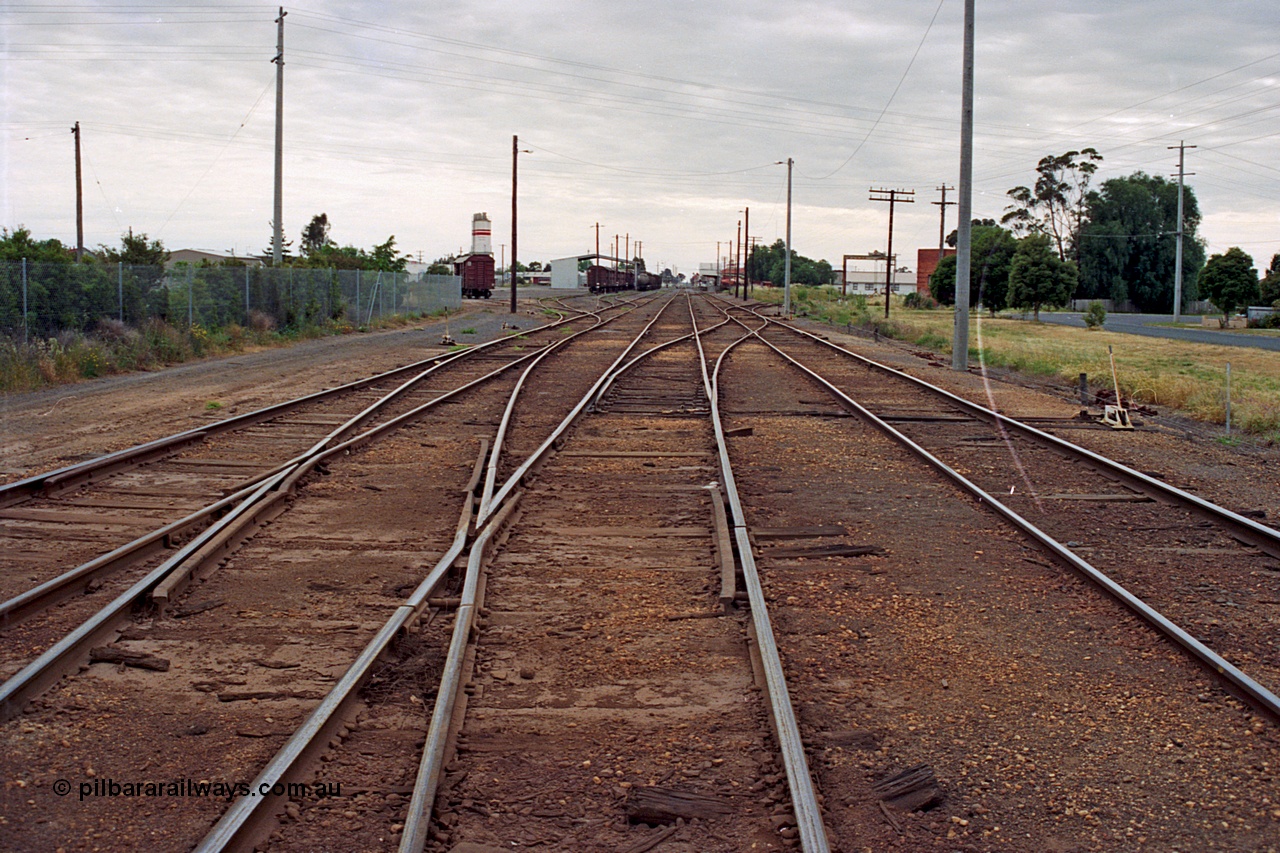 175-12
Shepparton station yard overview looking north, from No.2 Road or mainline, crossover from No.2 to No.1 Road leads into former weighbridge sidings, yard roads 3, 4 and 5 visible at left, also location of cement silos and Freight Gate canopy, station in the distance on the right.
