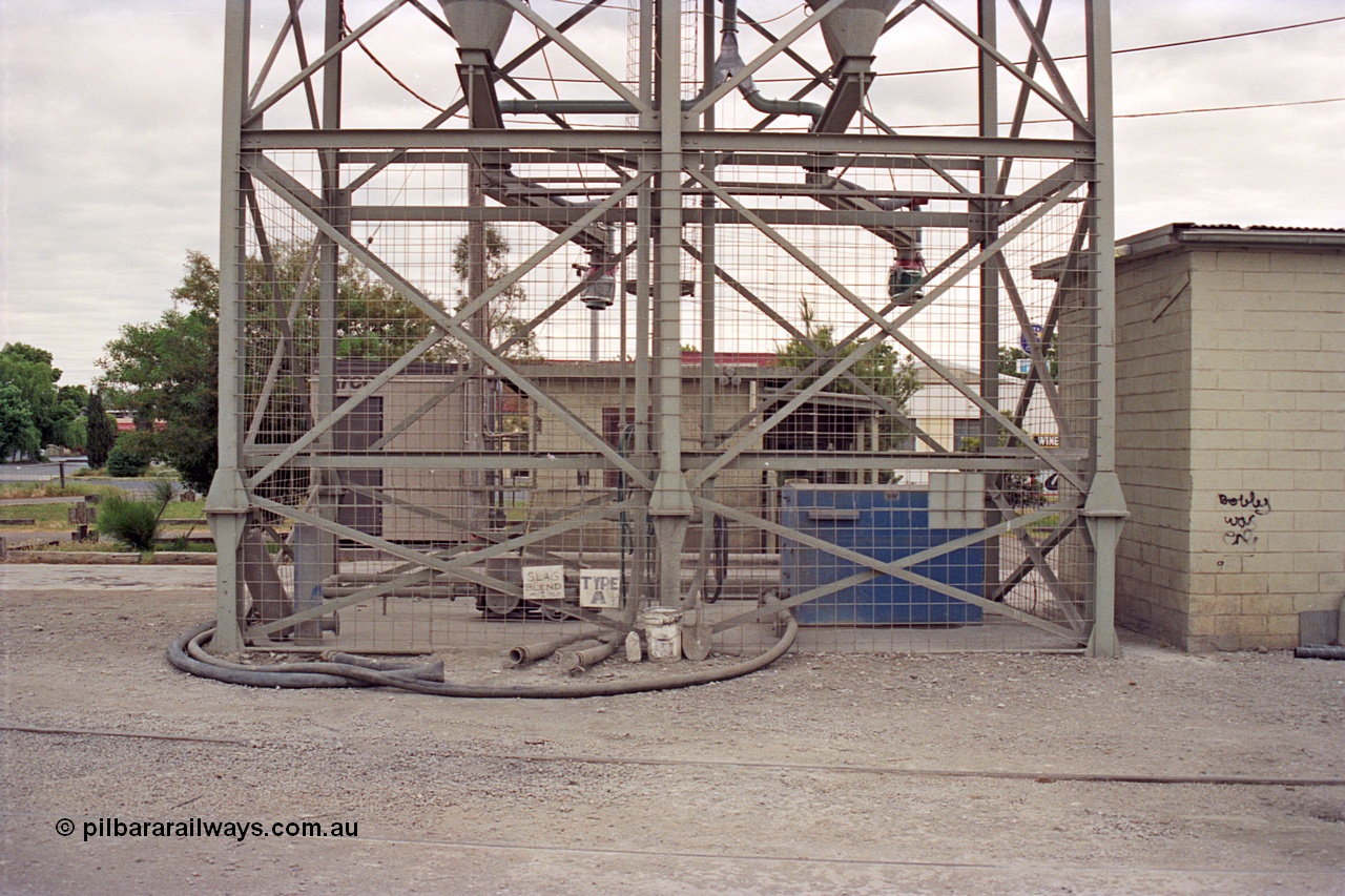 175-14
Shepparton, rail served industry, Australian Cement, waggon unloading area, base of silos looking across to truck loading area.
