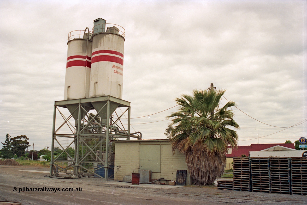175-16
Shepparton, rail served industry, Australian Cement, waggon unloading area, elevation of storage silos and structure arrangement, with brick control building, pallet stacks.
