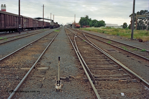 175-09
Shepparton station yard overview looking north, points and lever for No.2 to No.1 Rd cross-over which leads to the former Car Dock, now train examiner's siding, stabled goods and fuel trains on the left with the Freight Gate canopy, station building on the far right beyond examiner's siding.

