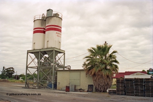 175-16
Shepparton, rail served industry, Australian Cement, waggon unloading area, elevation of storage silos and structure arrangement, with brick control building, pallet stacks.
