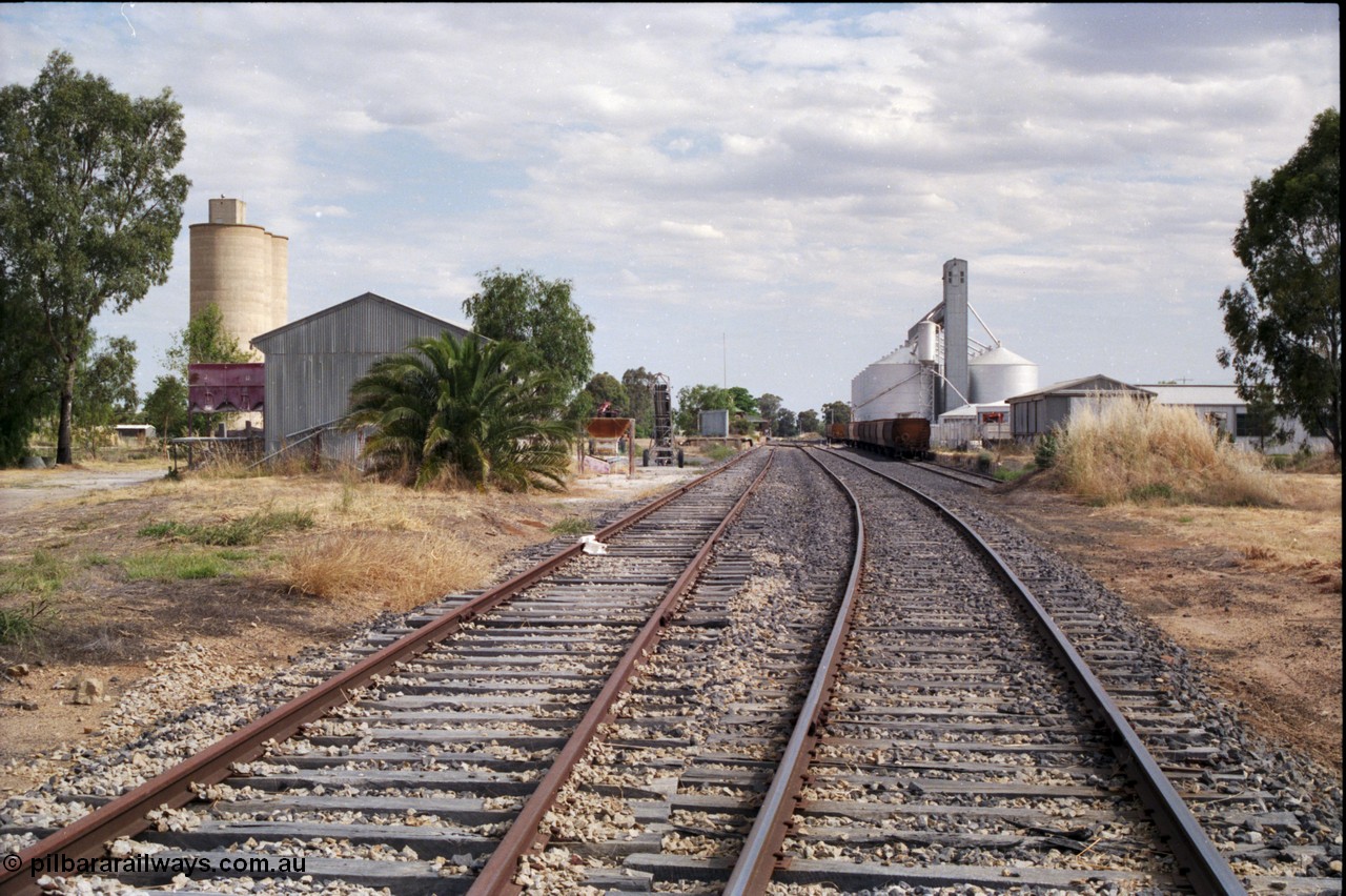 176-06
Yarrawonga station yard overview looking south, super phosphate shed and Williamstown style silo complex on the left, station building and platform in the middle distance, and GEB sub-terminal silo complex on the right.
