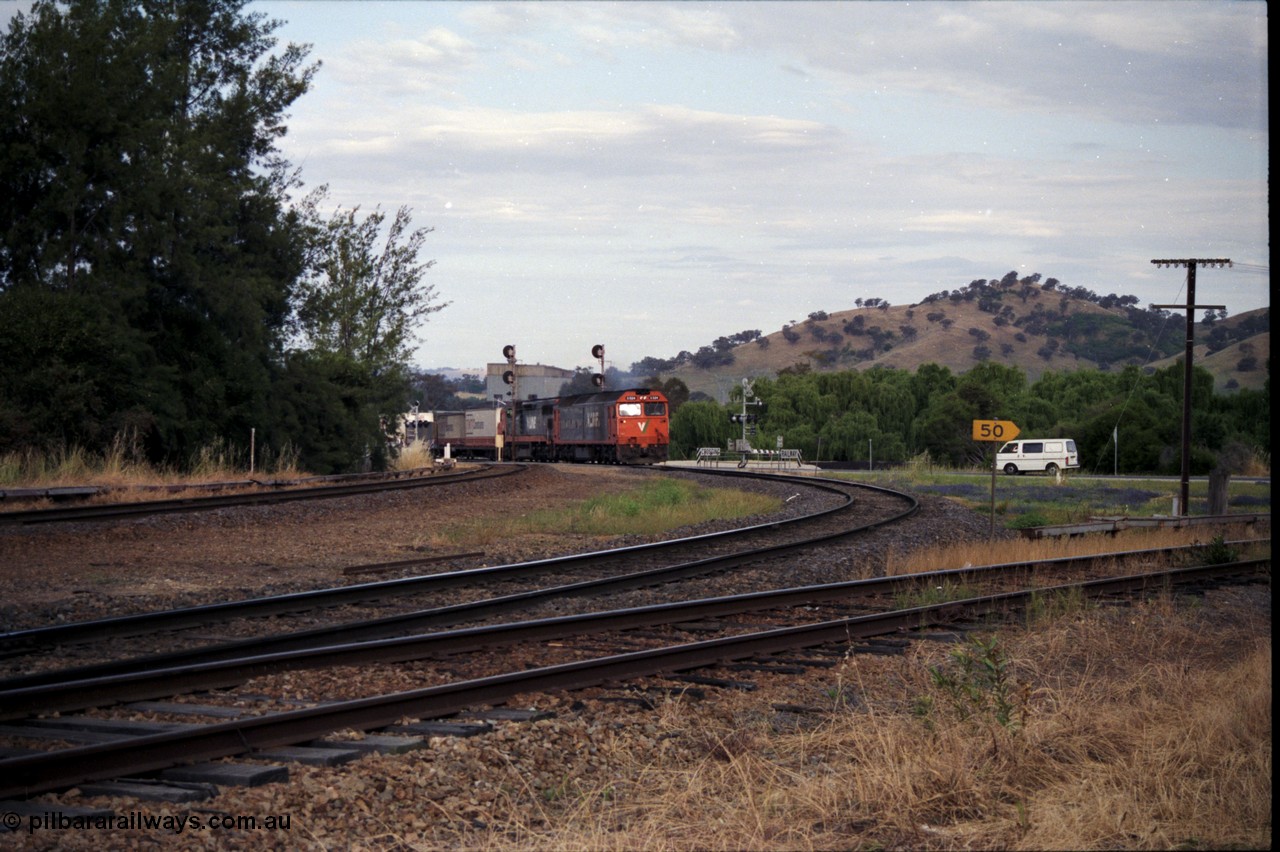 176-09
Wodonga, V/Line standard gauge up goods train passing the Wodonga Coal Sidings behind the G class G 524 Clyde Engineering EMD model JT26C-2SS serial 86-1237 and C class C 505 Clyde Engineering EMD model GT26C serial 76-828 combination, broad gauge track on the left, and the former broad gauge line to Bandiana and Cudgewa curving around to the right.
Keywords: G-class;G524;Clyde-Engineering-Rosewater-SA;EMD;JT26C-2SS;86-1237;