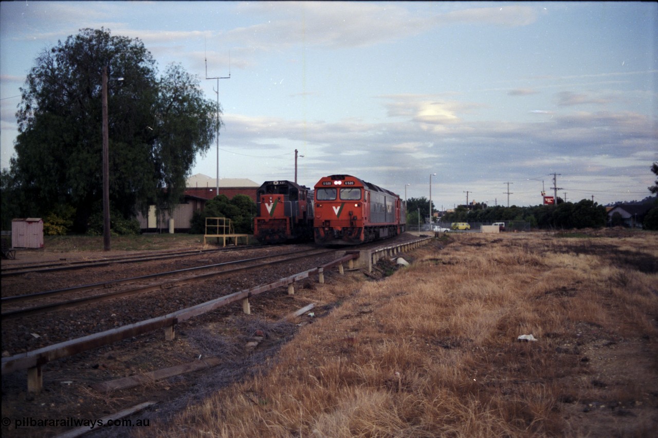 176-22
Wodonga, V/Line standard gauge 'stand-by' loco X class 2nd Series leader X 37 Clyde Engineering EMD model G26C serial 70-700 sits in the Diesel Siding behind the station, as an up Melbourne bound goods train passes behind G class G 520 Clyde Engineering EMD model JT26C-2SS serial 85-1233 and a sister unit, the area to the right is the former broad gauge Cattle Sidings 4 and 5 and the Amoco Siding.
Keywords: G-class;G520;Clyde-Engineering-Rosewater-SA;EMD;JT26C-2SS;85-1233;