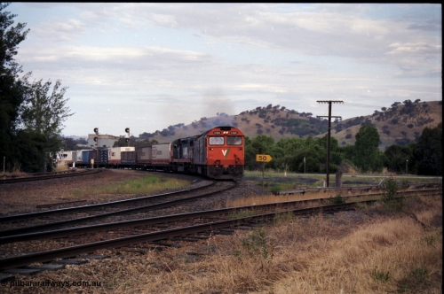 176-12
Wodonga, V/Line standard gauge up goods train passing the Wodonga Coal Sidings behind the G class G 524 Clyde Engineering EMD model JT26C-2SS serial 86-1237 and C class C 505 Clyde Engineering EMD model GT26C serial 76-828 combination, broad gauge track on the left, and the former broad gauge line to Bandiana and Cudgewa curving around to the right.
Keywords: G-class;G524;Clyde-Engineering-Rosewater-SA;EMD;JT26C-2SS;86-1237;